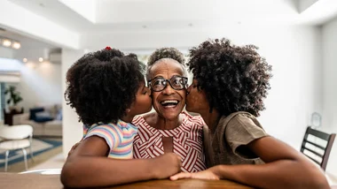 Grandmother kissed by daughter and granddaughter