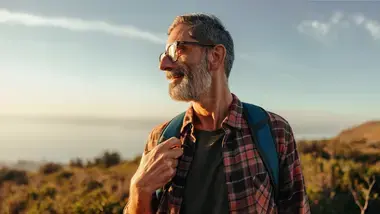 Older man hiking with backpack