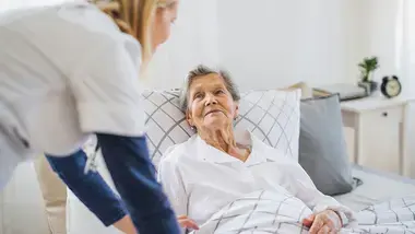 Woman in bed in nursing home
