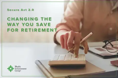 Closeup of a person&#39;s hand on a calculator as they do their taxes. In green, the words &quot;Secure Act 2.0 Changing the Way You Save for Retirement&quot; are superimposed over the image.