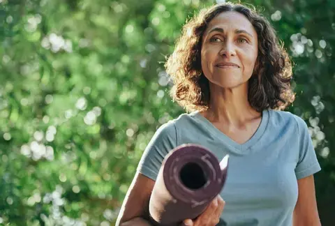 Woman with yoga mat.