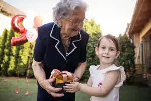 Grandmother and granddaughter celebrating grandmother's birthday
