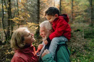 Grandparents with grandchild on grandfather's shoulders