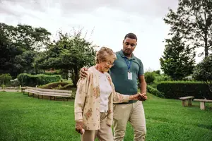 Woman with caretaker at nursing home