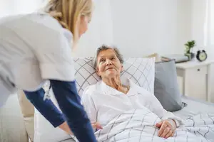 Woman in bed in nursing home